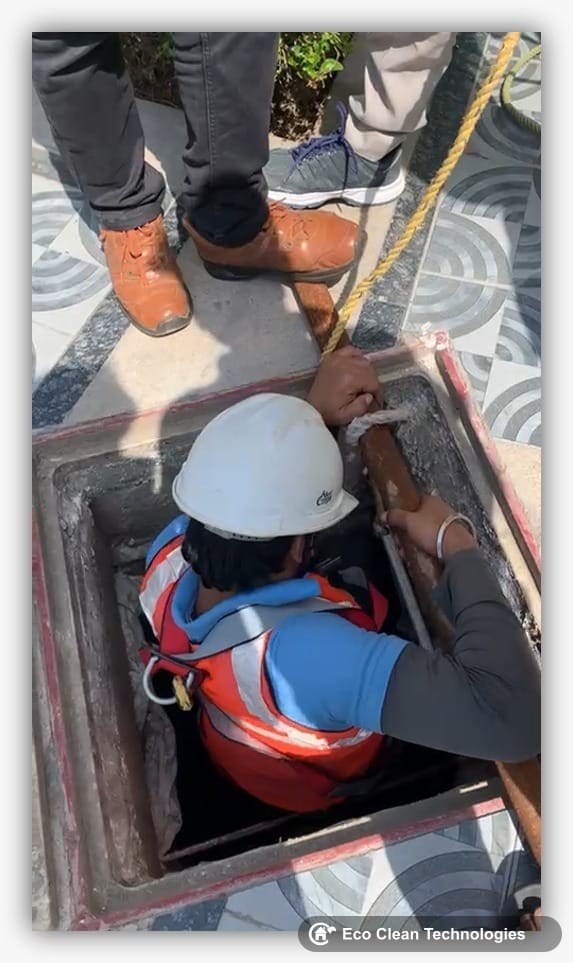 Worker entering tank with safety rope