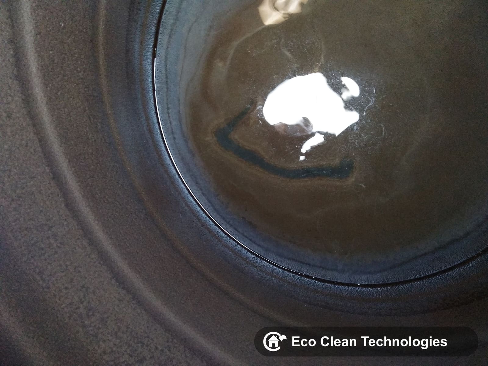 Muddy tank floor before cleaning