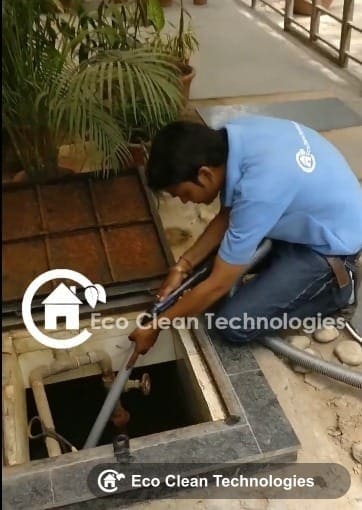 Eco Clean Technologies technician cleaning an overhead water tank