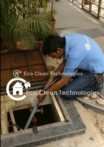 Eco Clean Technologies technician cleaning an overhead water tank