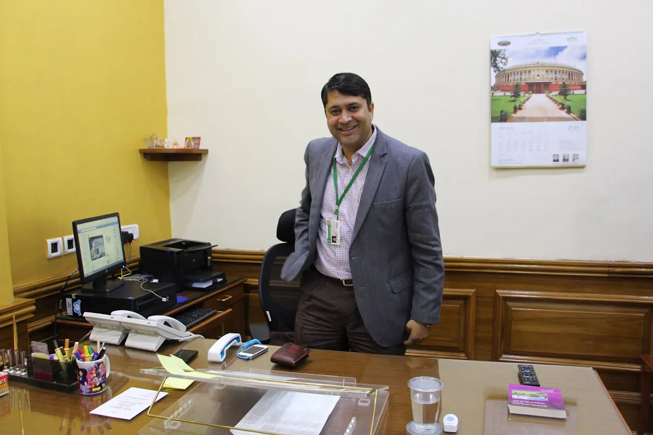 Sumit Singh smiling at his desk